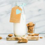 Fresh homemade dairy-free almond milk with craft paper label