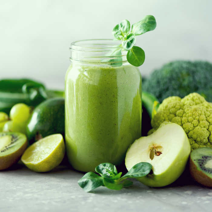 Glass jar mugs with green health smoothie. Copy space. Vegan, vegetarian concept. Alkaline food