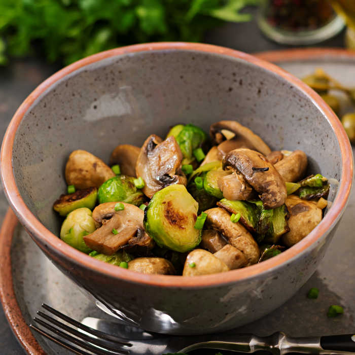Vegan dish. Baked mushrooms with Brussels sprouts and herbs. Proper nutrition. Healthy lifestyle