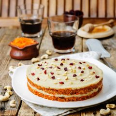 raw vegan carrot cake with cashew cream and dried cranberries